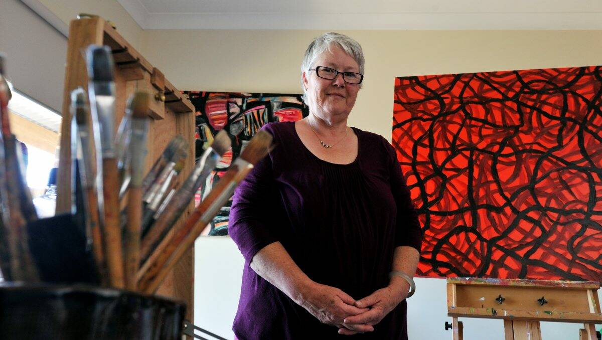 Ballarat artist Dawn Lim with the two paintings she is donating to the fundraiser to fight demolition of the Civic Hall. PICTURE: JEREMY BANNISTER