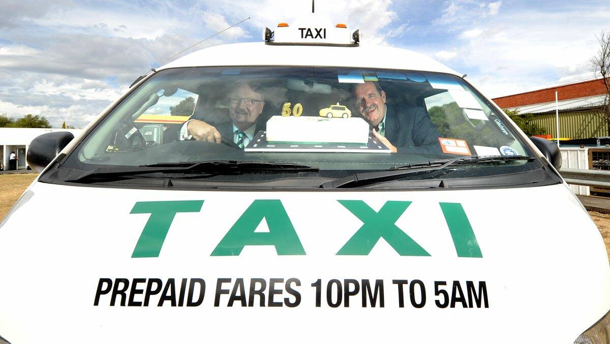 Victorian Taxi Association president Kevin Gange and Ballarat Taxis president and chairman Stephen Armstrong inside one of Ballarat’s white taxis.