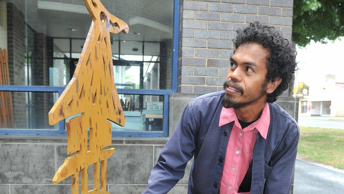Artist Marqy da Costa with his sculpture representing the close ties between the people of Ballarat and East Timor. 