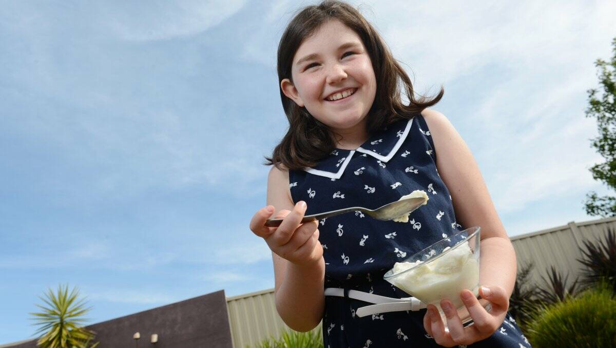 Harper Fitzpatrick, 9, enjoying a bowl of ice cream yesterday as the temperature reached a top of 25 degrees. 