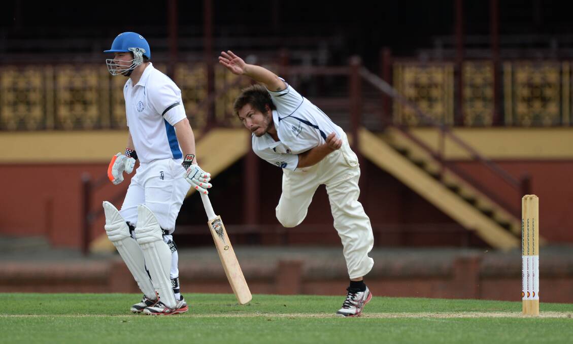 Mt Clear's Jarrod Burns sends down a delivery, while Golden Point's Andrew Falkner looks on. Picture - Adam Trafford.