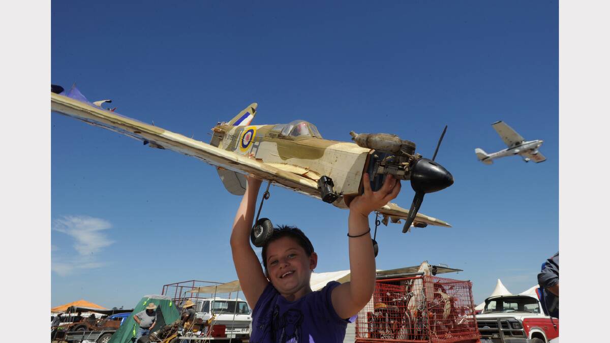 2010: Zoe Waler, then 8, from Barellan with a model spitfire her father bought at the meet. PICTURE: JEREMY BANNISTER