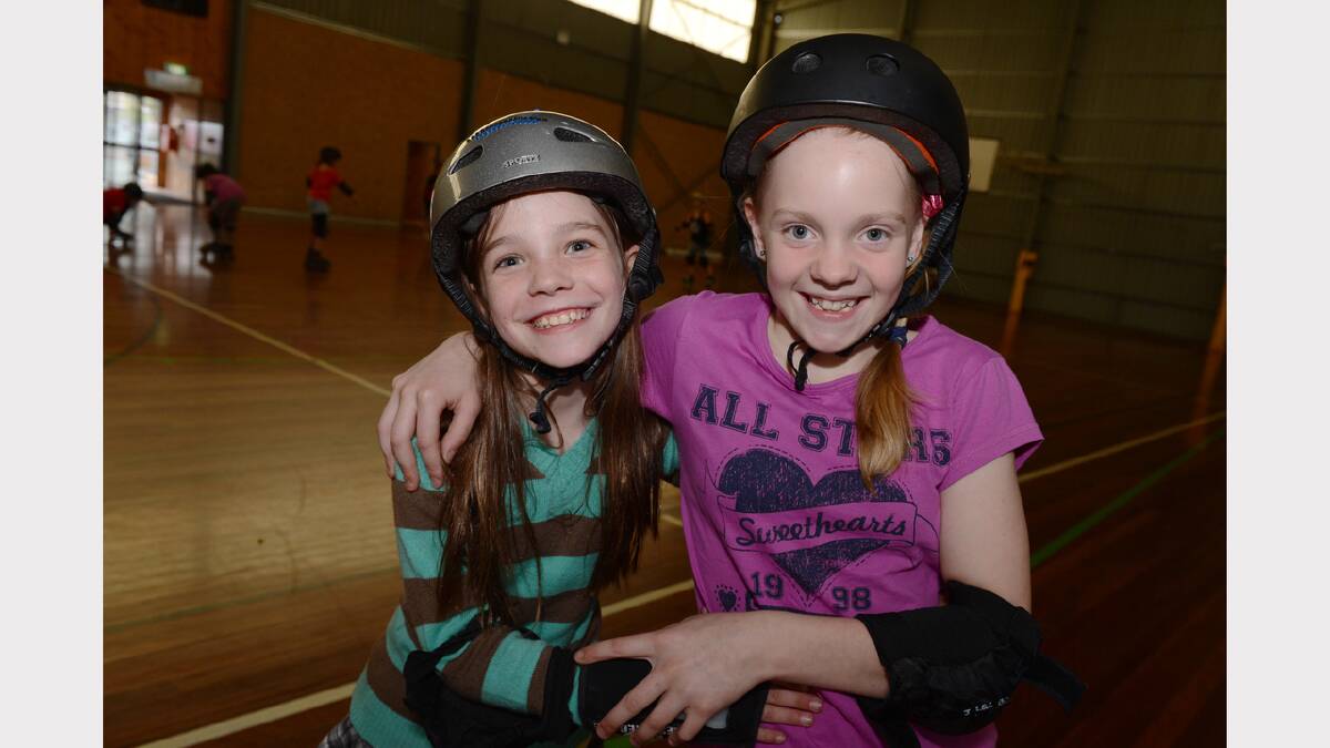 Ella Price, 9, and Tahlia Blackmore, 12, at the school holidays fun skate session at the Doug Deans Sports Stadium. PICTURE: KATE HEALY. 