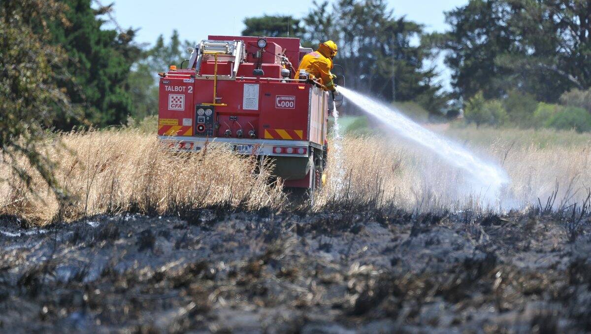 Firefighters battle a fire near Waubra this afternoon. PICTURE: LACHLAN BENCE