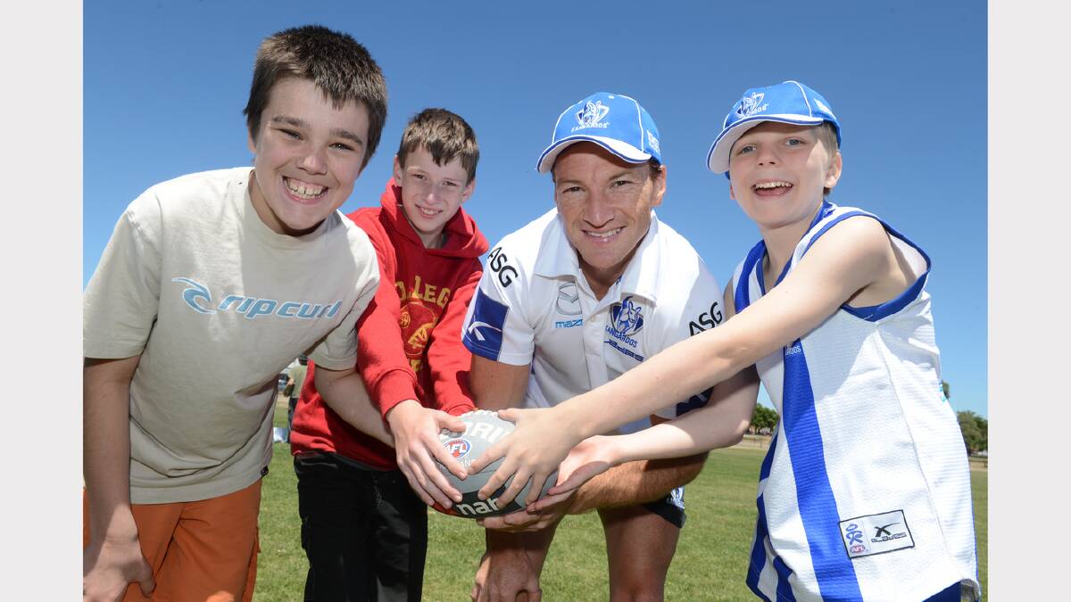 Jake McDonald, 13, Jordan Sanders, 12, North Melbourne's Brent Harvey and Josh Johnson, 12 at the Specialist School. PICTURE: KATE HEALY