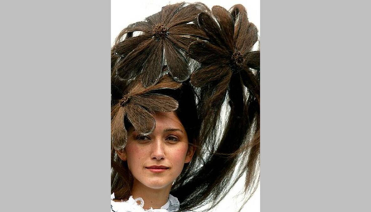 Silvana Lovin, wearing a hat made from hair, poses during the Fashions on the Field parade at the 2002 Melbourne Cup. Photo: REUTERS