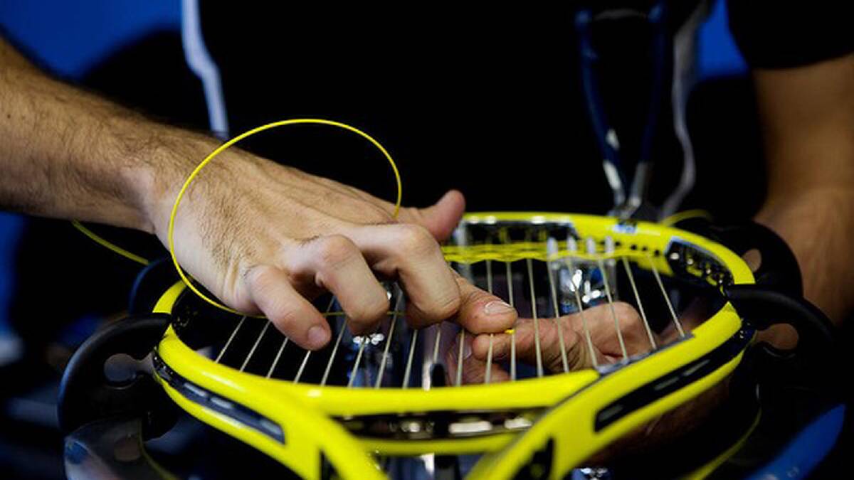 Official stringers lace player's tennis racquets at Melbourne Park. Photo: Paul Jeffers