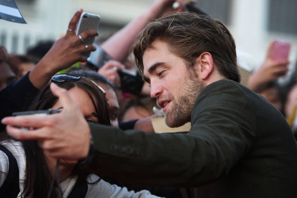 Robert Pattinson poses with fans during a 'Breaking Dawn - Part 2' fan event at Fox Studios on October 22, 2012 in Sydney, Australia. Photo by Lisa Maree Williams/Getty Images