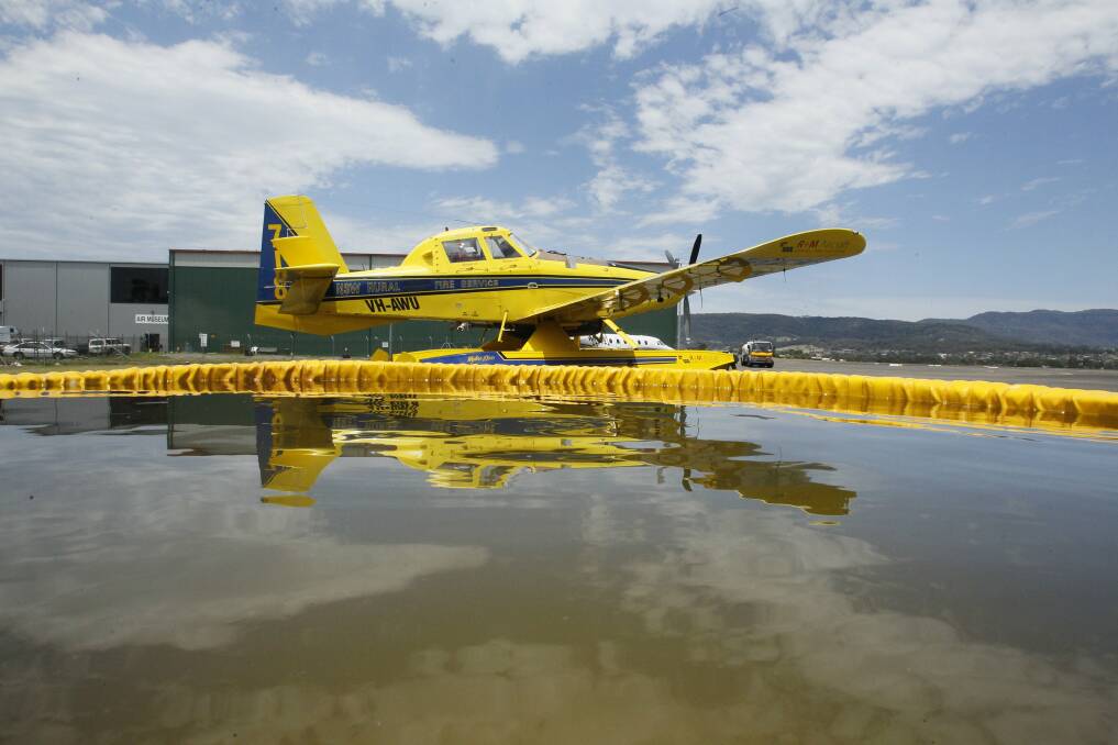 A fire bombing plane sits at the ready at the Illawarra Regional Airport. Photo: Dave Tease