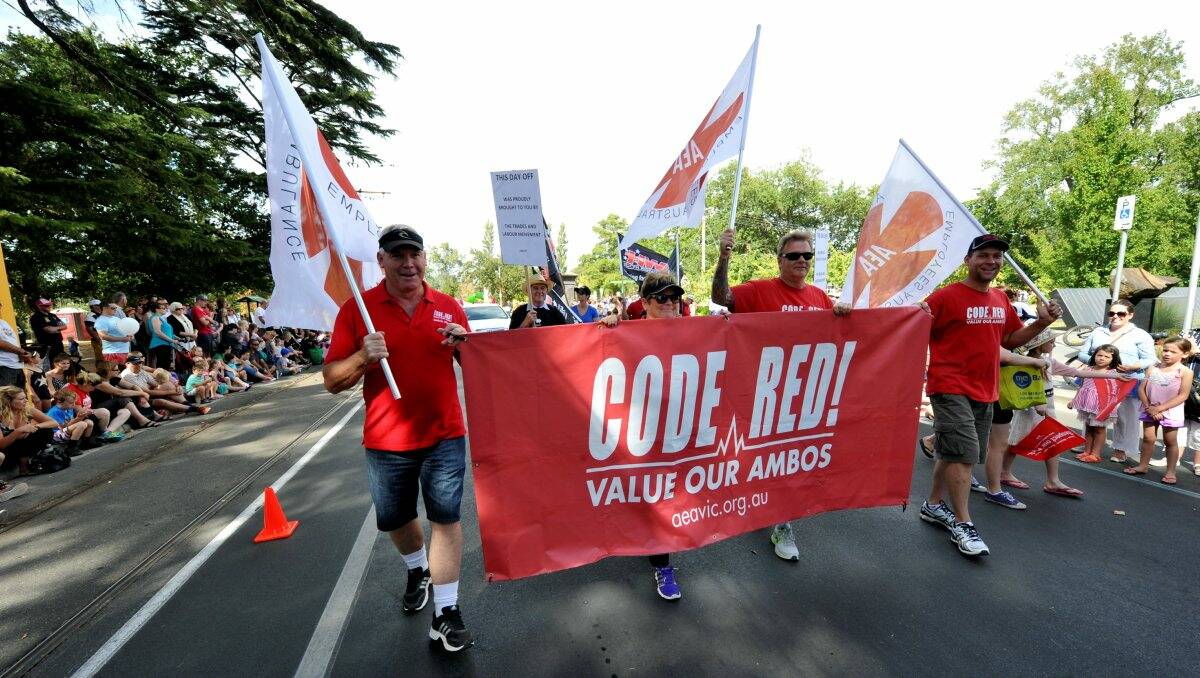 Ballarat Trades Hall members take part in the Begonia Festival Parade, carrying a banner which said 'Code Red: Save our Ambos'.