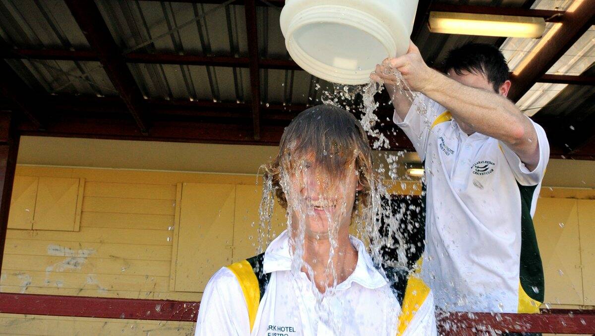 Ballarat Redan bowler Toby Hutt gets a cooling down thanks to his captain, Allister Edmunds.