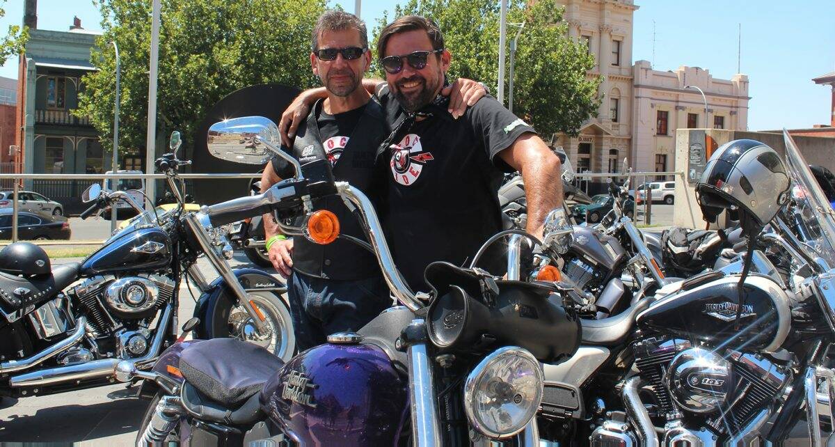 Headspace CEO Chris Tanti and Grinspoon lead singer Phil Jamieson at the Rock ‘N’ Ride event in Camp Street yesterday.