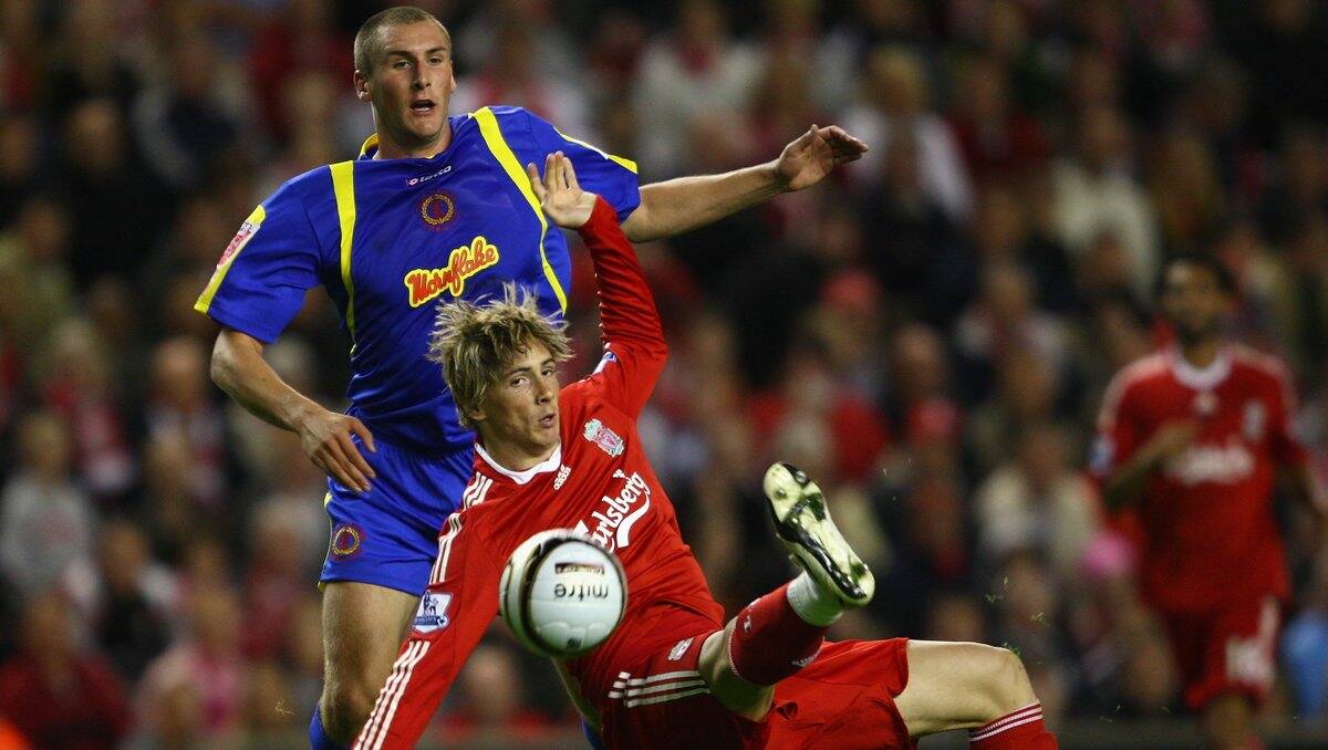 Danny O’Donnell (representing Crewe Alexander) challenges former Liverpool teammate Fernando Torres during their English League Cup clash at Anfield in 2008. 
