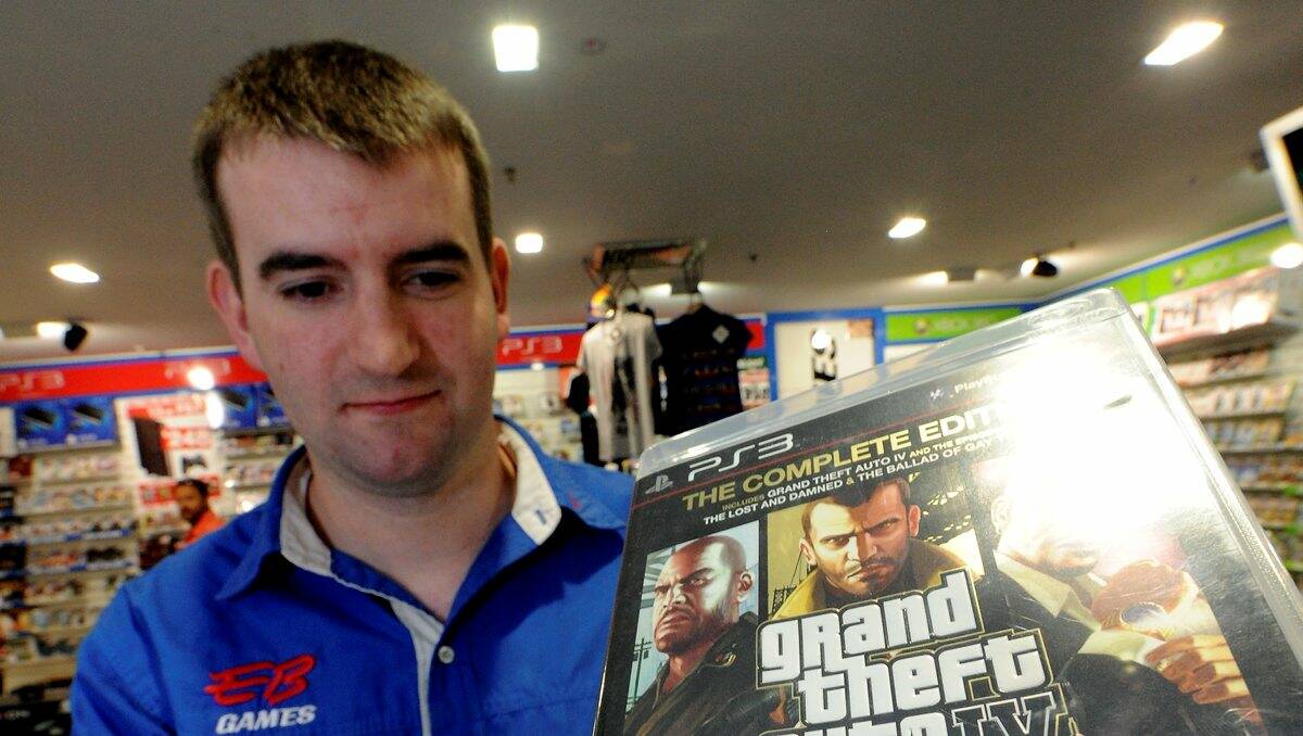 EB Games Central Square assistant manager Brad Jackson with an MA 15+ game, previously the highest rating for games in Australia. PICTURE: JEREMY BANNISTER