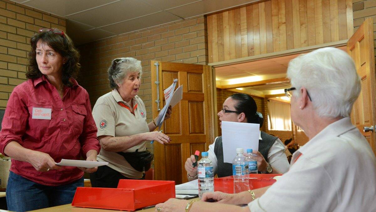 Deb Shaddock and Nora Stubbs with other Red Cross officials at the evacuation centre at the Newlyn football ground. PICTURE: ADAM TRAFFORD