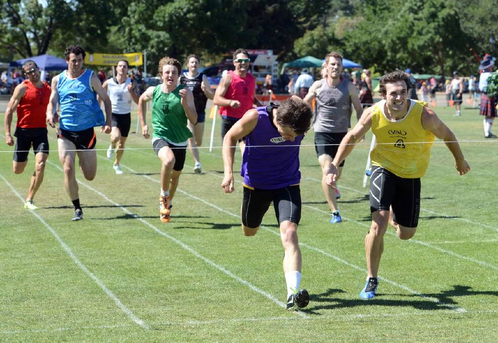 Sam Baird puts his head down in a frantic bid to edge himself over the line in front of Jake Dooley in the novice 400 metres event.