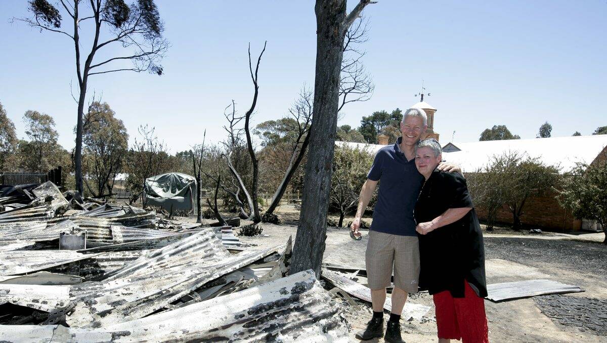 CFA volunteer Michael Unwin and Kath Ginnane standing next to the remains of her shed. Mr Unwin helped save Ms Ginnane’s home from Tuesday’s fire.