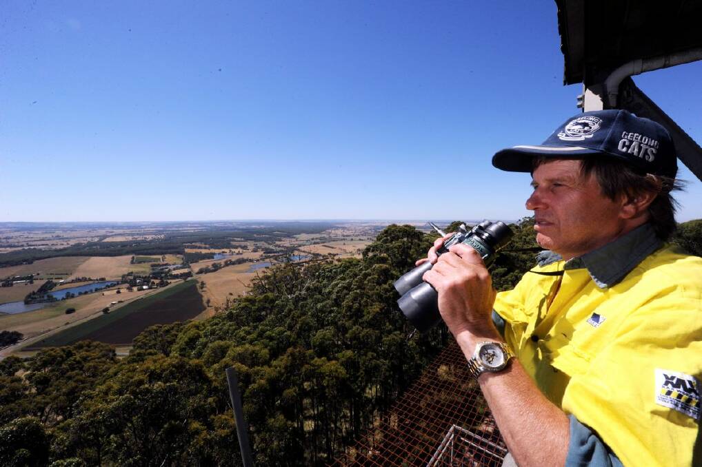 Fire spotter Wayne McGuire keeps a close eye on the countryside from the Mount Buninyong tower yesterday. 