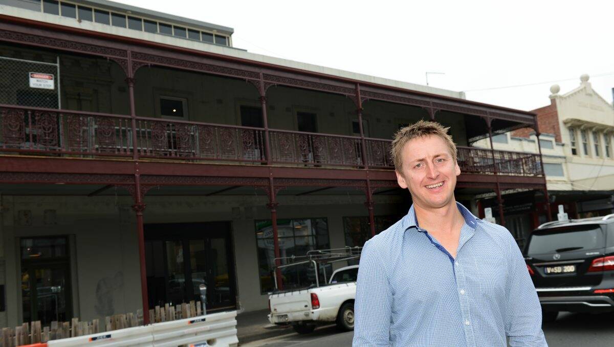 EXCITED: Jackson’s & Co director Brian Taylor in front of the new balcony and (inset) the verandah about to be pulled down in the 1960s when it was the Railway Hotel. PICTURE: KATE HEALY
