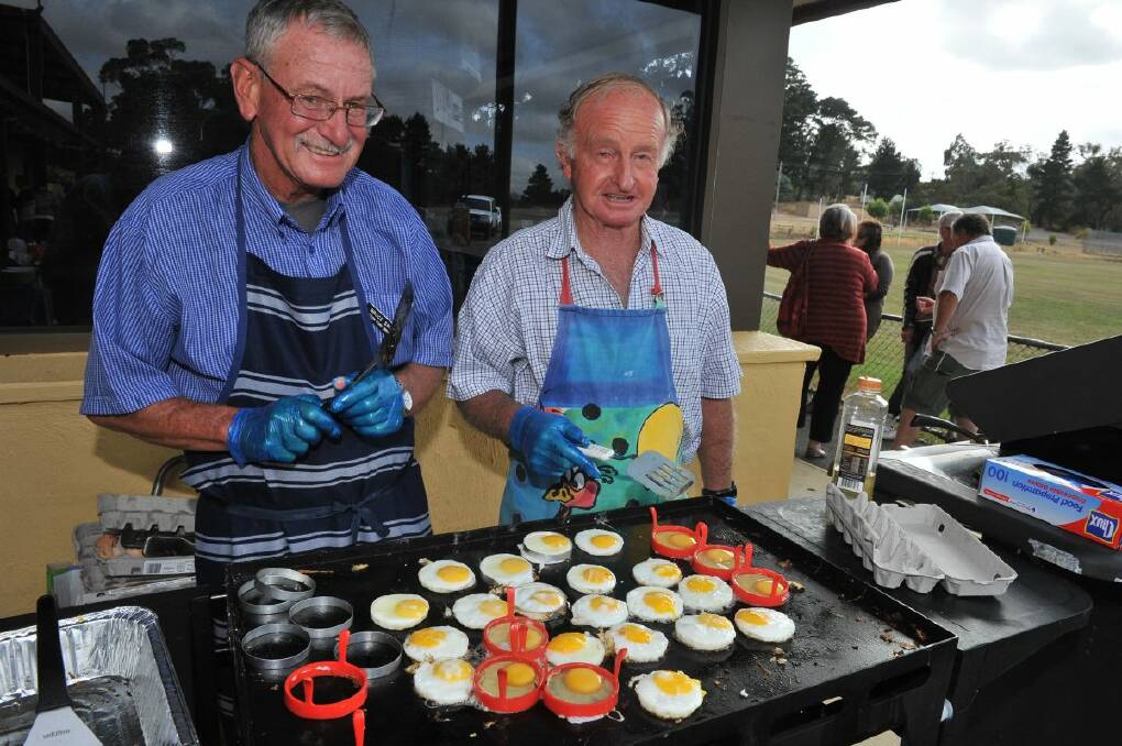 Bruce Smith and Tim Cooke busy on the BBQ at the Linton Australia Day breakfast.