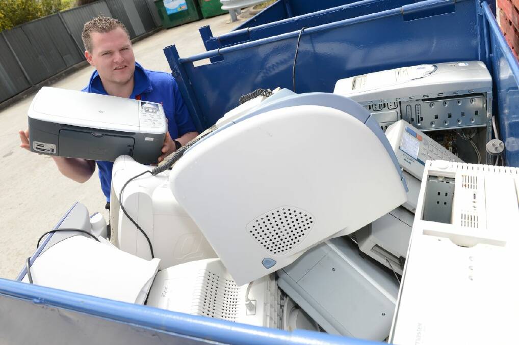 Nathan Hunt from Officeworks with some of the old computer equipment that has been collected for recycling. PICTURE: KATE HEALY