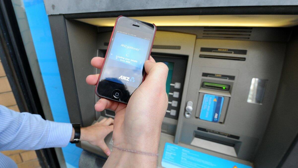 A person uses a mobile phone at an atm in clear view of the public amid warnings that young people are complacent about protecting their identity. PICTURE: JORDAN OLIVER