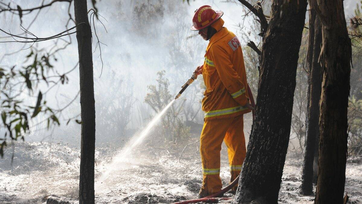 Clean up: A firefighter puts out a fire as the CFA urges people to start cleaning their properties before fire restrictions begin.