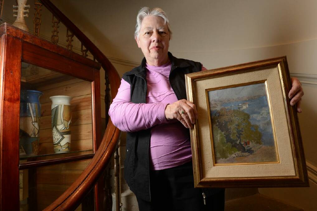 Creswick Museum secretary Margaret Fullwood holds Percy Lindsay’s work Berrys Bay. PICTURE: ADAM TRAFFORD