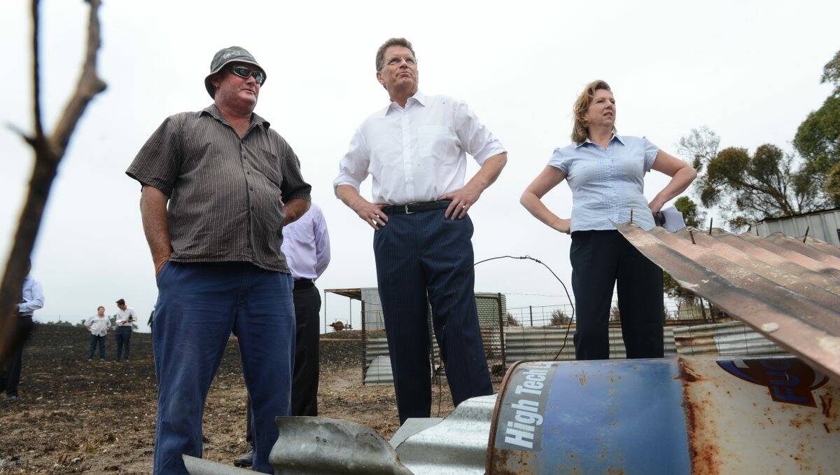 ASSISTANCE: Carngham landowner Kim Nunn, Victorian Premier Ted Baillieu and Ballarat MP Catherine King inspect the Nunns’ property yesterday after the announcement that low-interest loans will be made available for certain groups affected by the recent Chepstowe and Carngham fires. PICTURE: ADAM TRAFFORD