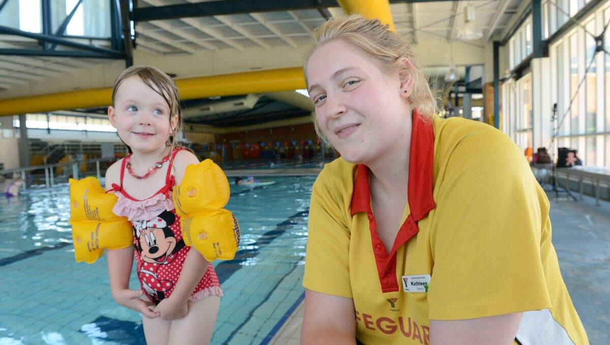 Marley Constable, 4, with YMCA Lifeguard Kathleen O’Meara. PICTURE: ADAM TRAFFORD