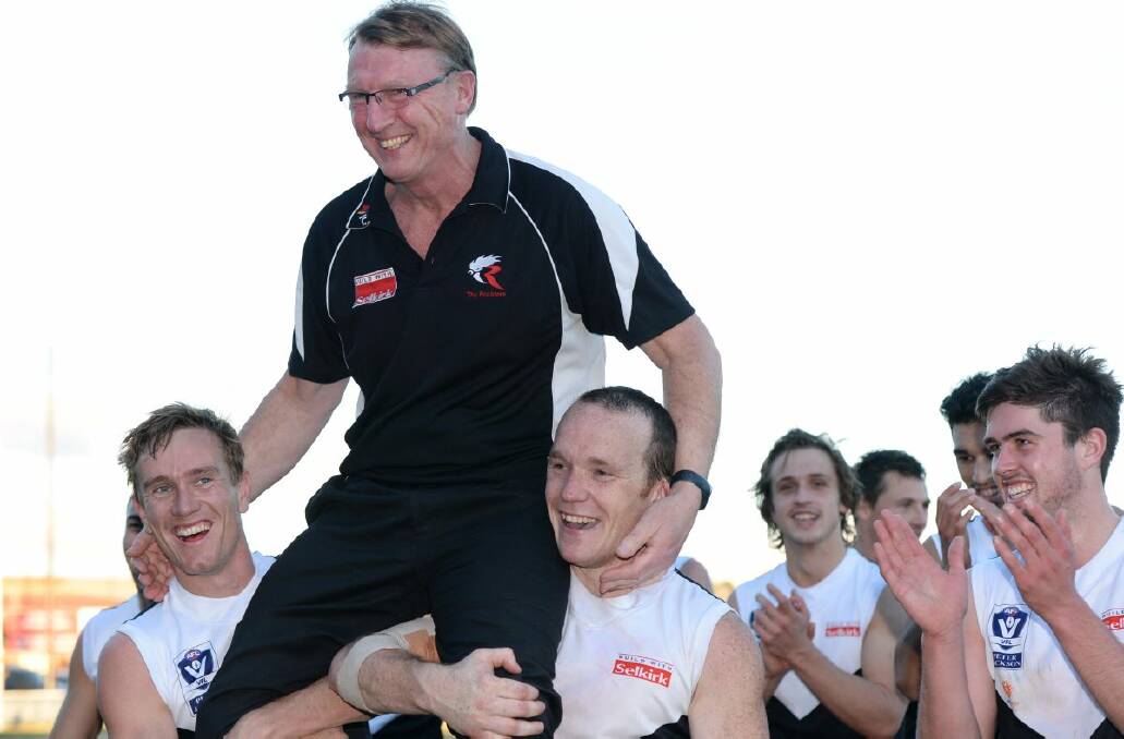North Ballarat Roosters players Myles Sewell, left, and Steve Clifton chair their coach Gerard FitzGerald from the ground after his 300th game coaching a VFL side at Eureka Stadium on Saturday. 