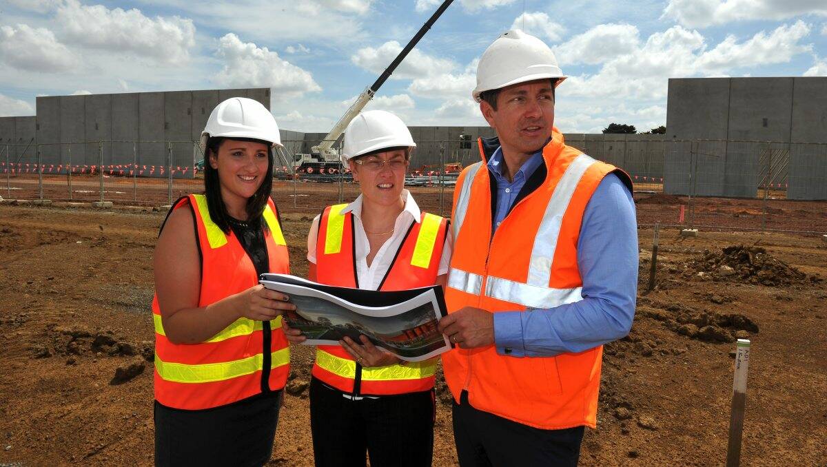 Ballarat City Councillors Amy Johnson and Vicki Coltman and Integra Victorian manager Nick Grylewicz inspect the building site.