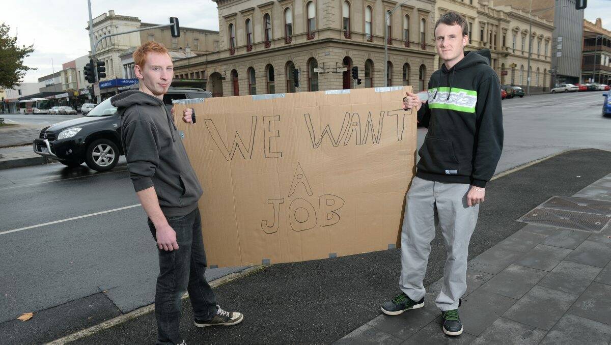 David Dixon and Callagun Mann with their sign at the corner of Sturt and Lydiard streets in Ballarat yesterday.