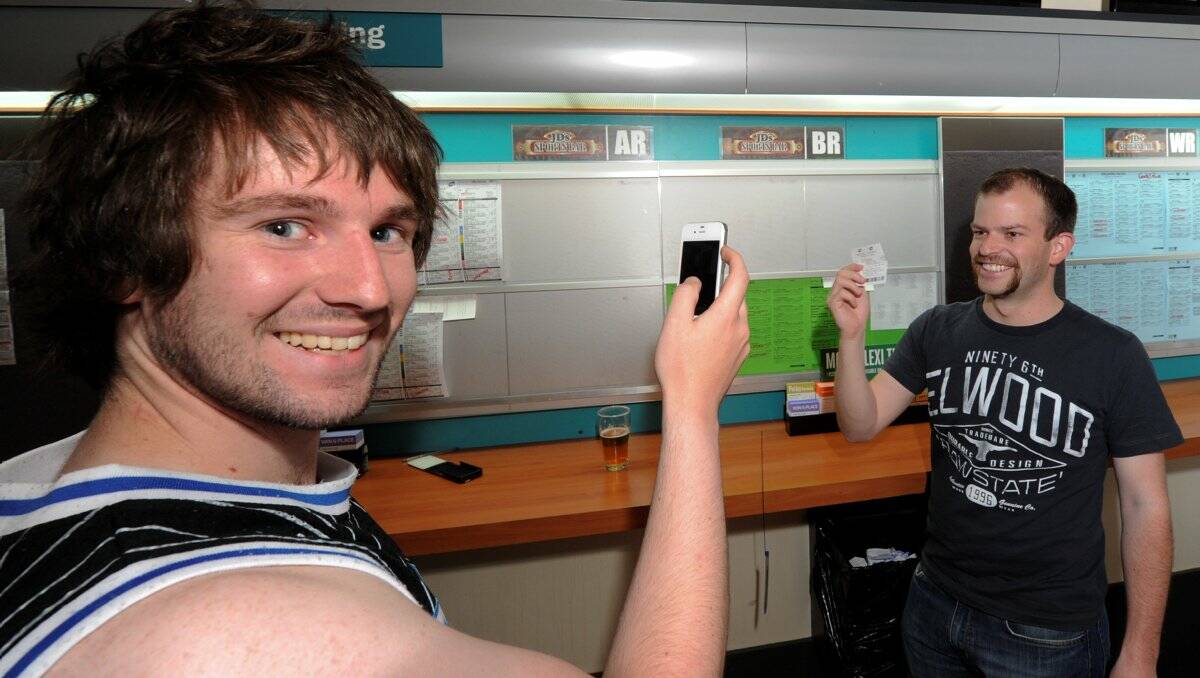 Chris Lawrey and Simon Curtain celebrate in JD’s Sports Bar.