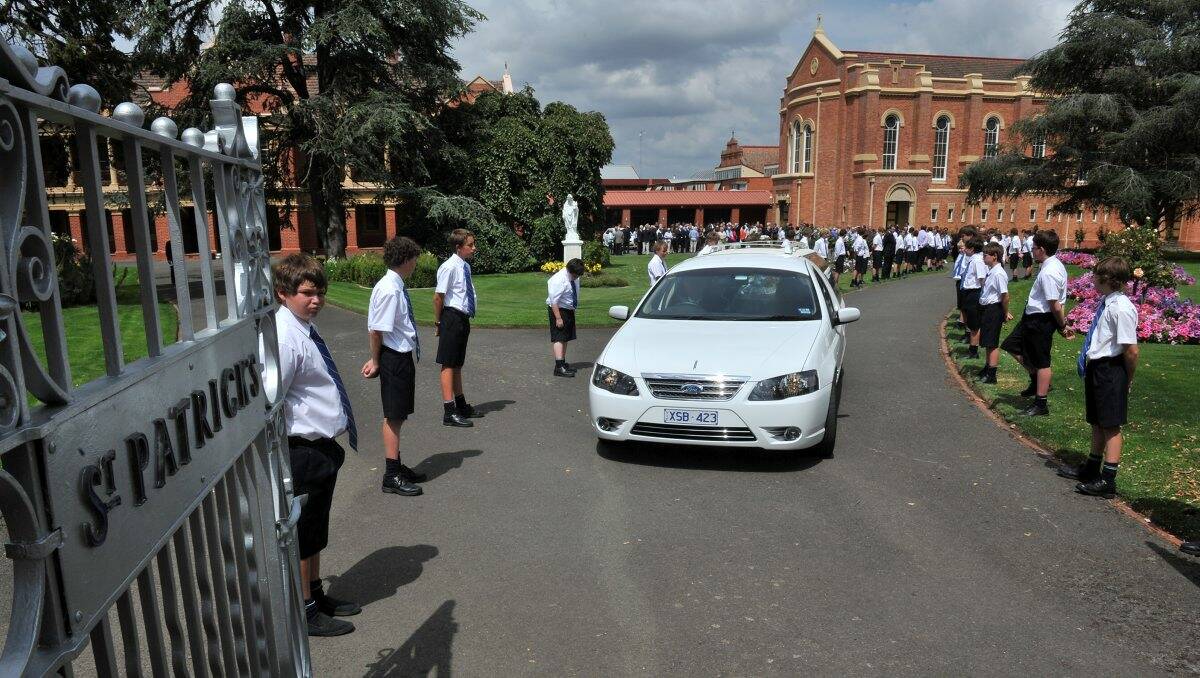 Students form a guard of honour after the service at the college.