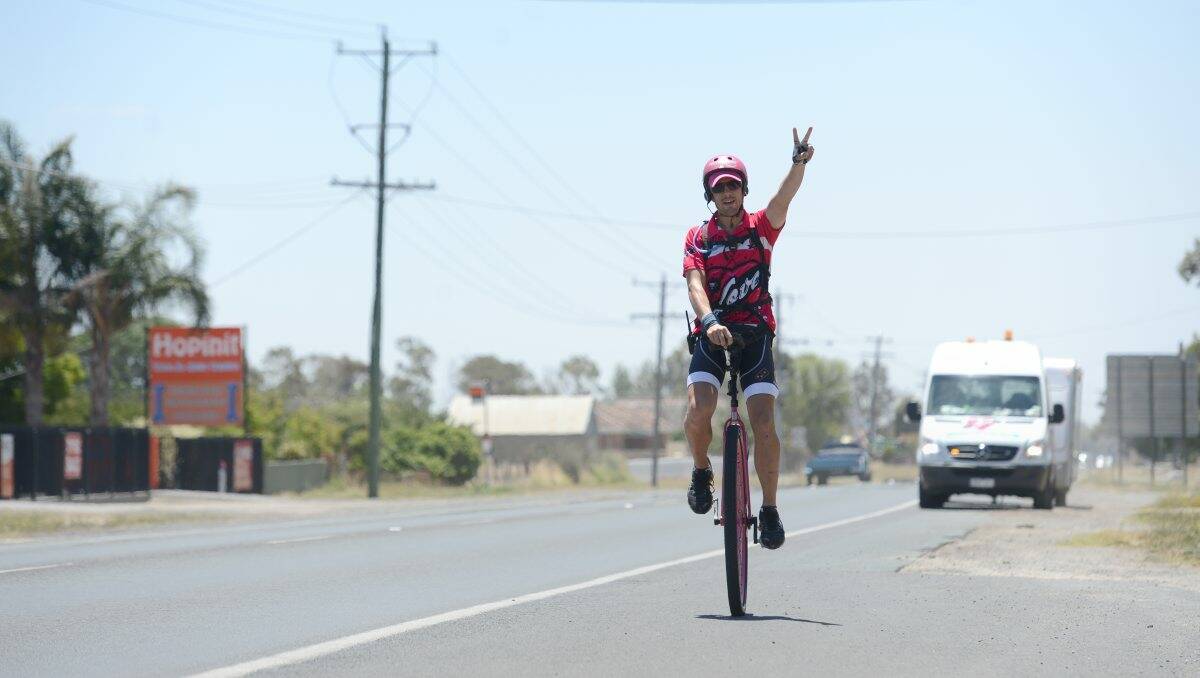 SUPPORT: Samuel Johnson rides into Bendigo as part of his fundraising marathon. PICTURE: Jim Aldersey