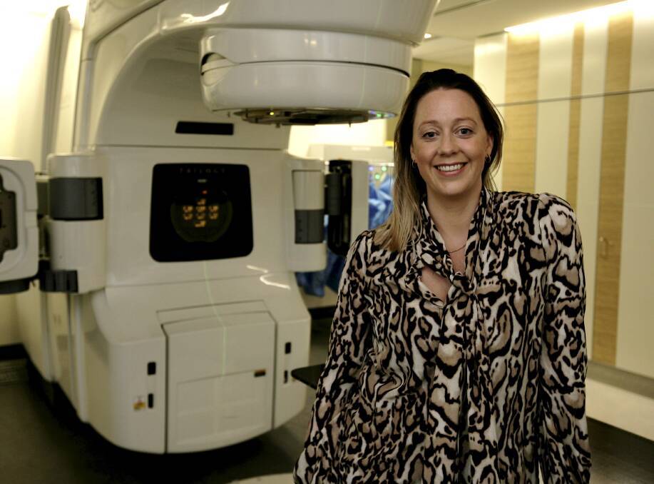 Radiation oncologist Simone Reeves with a linear accelerator at the cancer centre. 